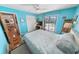 Bright bedroom features a sliding glass door leading to a screened patio and pool at 4350 Candlewood Ln, Ponce Inlet, FL 32127