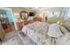 Inviting bedroom with a brass bed, wooden furniture, tile floors and an abundance of natural light at 4350 Candlewood Ln, Ponce Inlet, FL 32127