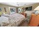 Comfortable bedroom featuring a brass bed frame and a view of the private pool area at 4350 Candlewood Ln, Ponce Inlet, FL 32127