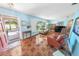 Inviting living room featuring tiled floors, large windows, comfortable seating, and natural light at 4350 Candlewood Ln, Ponce Inlet, FL 32127
