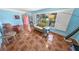 Comfortable living room area with tiled floors, cozy seating, and windows offering views of the outdoors at 4350 Candlewood Ln, Ponce Inlet, FL 32127