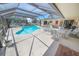 The screened-in pool boasts plenty of room for outdoor dining and lounging at 4350 Candlewood Ln, Ponce Inlet, FL 32127
