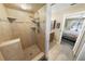 Tiled walk-in shower featuring a handheld shower head and recessed shelving, connected to bath at 4350 Candlewood Ln, Ponce Inlet, FL 32127