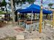 Outdoor bar area featuring a blue canopy, wooden bar top, and seating, perfect for entertaining at 439 Bouchelle Dr # 202, New Smyrna Beach, FL 32169