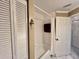 Compact bathroom featuring a shower-tub combo, white cabinets, and a large closet at 439 Bouchelle Dr # 202, New Smyrna Beach, FL 32169
