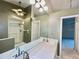 Bright bathroom with dual sinks, large mirrors, walk-in shower and tile flooring at 439 Bouchelle Dr # 202, New Smyrna Beach, FL 32169