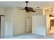 Spacious carpeted bedroom with ceiling fan and views into an adjacent space at 439 Bouchelle Dr # 202, New Smyrna Beach, FL 32169