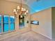 Dining area with a chandelier, large windows, and mirrored wall at 439 Bouchelle Dr # 202, New Smyrna Beach, FL 32169