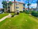 A meticulously manicured lawn includes a walkway, trees, and golf balls at 439 Bouchelle Dr # 202, New Smyrna Beach, FL 32169