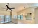 Bright living room with vaulted ceilings, fan, chandelier and sliding glass doors at 439 Bouchelle Dr # 202, New Smyrna Beach, FL 32169