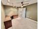 The carpeted office room has a ceiling fan, track lights and a door to the bathroom at 439 Bouchelle Dr # 202, New Smyrna Beach, FL 32169