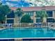 Community pool with comfortable loungers, offering a relaxing escape at 439 Bouchelle Dr # 202, New Smyrna Beach, FL 32169