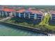 Attractive aerial view of waterfront condos with lush landscaping and beautiful water access at 460 Bouchelle Dr # 104, New Smyrna Beach, FL 32169