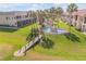 Expansive aerial view of landscaped grounds with a bridge and fountain feature at 460 Bouchelle Dr # 104, New Smyrna Beach, FL 32169