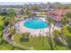 Relaxing aerial view of a community pool with ample lounge chairs and well manicured landscaping at 460 Bouchelle Dr # 104, New Smyrna Beach, FL 32169