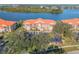 Aerial view showcases the condos with meticulous landscaping, parking, and lush surroundings at 460 Bouchelle Dr # 104, New Smyrna Beach, FL 32169