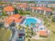 Beautiful aerial view of a community pool surrounded by condo buildings and green spaces at 460 Bouchelle Dr # 104, New Smyrna Beach, FL 32169