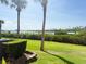 The home's backyard boasts a pristine green lawn, punctuated by swaying palm trees and scenic views at 460 Bouchelle Dr # 104, New Smyrna Beach, FL 32169