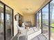 A cozy screened balcony with comfortable seating and a lovely view of the surrounding landscape at 460 Bouchelle Dr # 104, New Smyrna Beach, FL 32169