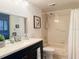 Bright bathroom with single vanity and tub shower combo with shower curtain at 460 Bouchelle Dr # 104, New Smyrna Beach, FL 32169
