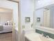 Bright bathroom featuring double vanity that opens to the Primary bedroom at 460 Bouchelle Dr # 104, New Smyrna Beach, FL 32169