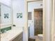 Bright bathroom featuring double vanity, decorative wall art and walk-in shower at 460 Bouchelle Dr # 104, New Smyrna Beach, FL 32169