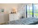 Cozy bedroom featuring simple decorations, a nice dresser, and plenty of natural light at 460 Bouchelle Dr # 104, New Smyrna Beach, FL 32169