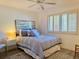 Comfortable bedroom with queen-sized bed, plush bedding and shuttered window at 460 Bouchelle Dr # 104, New Smyrna Beach, FL 32169
