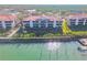 Waterfront condo complex featuring a pier and beautiful balconies overlooking the water at 460 Bouchelle Dr # 104, New Smyrna Beach, FL 32169