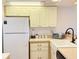 A well-lit kitchen featuring clean white appliances and classic cabinetry, offering a practical cooking space at 460 Bouchelle Dr # 104, New Smyrna Beach, FL 32169