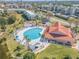 A large community pool and clubhouse surrounded by lush landscaping at 460 Bouchelle Dr # 104, New Smyrna Beach, FL 32169