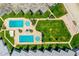 An aerial view showcases lush lawns and sparkling pools at this condo complex located steps from the beach at 4841 Saxon Dr # C201, New Smyrna Beach, FL 32169