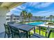 Beautiful balcony view of the pool, palm trees, and ocean beyond at 4841 Saxon Dr # C201, New Smyrna Beach, FL 32169