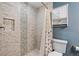 Elegant tiled shower and blue walls in a remodeled full bathroom at 4841 Saxon Dr # C201, New Smyrna Beach, FL 32169