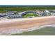 A scenic beachfront complex with direct access to a wide sandy beach and verdant lawn and pool areas at 4841 Saxon Dr # C201, New Smyrna Beach, FL 32169