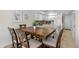 Dining area with a wooden table and seating for six, adjacent to the kitchen and open to the living space at 4841 Saxon Dr # C201, New Smyrna Beach, FL 32169