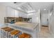 Well-equipped kitchen with stainless steel appliances, granite countertops, and ample cabinet space, with bar stool seating at 4841 Saxon Dr # C201, New Smyrna Beach, FL 32169