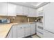 Bright kitchen with white cabinetry, stainless steel appliances, tile backsplash, and plenty of counter space for cooking at 4841 Saxon Dr # C201, New Smyrna Beach, FL 32169