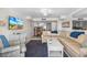 Open concept living room with access to kitchen and dining area, featuring comfortable seating and ocean views at 4841 Saxon Dr # C201, New Smyrna Beach, FL 32169