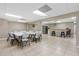 Well lit meeting room with long folding tables and seating, plus a kitchen area with fridge and seating at 4841 Saxon Dr # C201, New Smyrna Beach, FL 32169