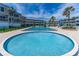 Community offers sparkling pool, lounge chairs, lush landscaping, and inviting atmosphere for relaxation and recreation at 4841 Saxon Dr # C201, New Smyrna Beach, FL 32169