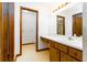 Well-lit bathroom featuring a large mirror, vanity with sink, and access to toilet and shower area at 5 Soco Trl, Ormond Beach, FL 32174