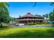 A two-story clubhouse with a wrap-around balcony and meticulously maintained landscaping at 5 Soco Trl, Ormond Beach, FL 32174