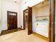 Functional entryway with laundry closet, classic wooden door, and unique flooring at 5 Soco Trl, Ormond Beach, FL 32174