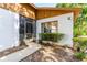 Inviting home exterior showcasing a screened door and a well-manicured garden at 5 Soco Trl, Ormond Beach, FL 32174