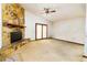 Living room features a stone fireplace, ceiling fan, and sliding glass door leading to outdoor space at 5 Soco Trl, Ormond Beach, FL 32174
