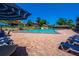 A vast outdoor community pool with brick pavers and lounge chairs on a sunny day at 5 Soco Trl, Ormond Beach, FL 32174