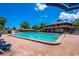 A large outdoor community swimming pool with lounge chairs and clear blue skies at 5 Soco Trl, Ormond Beach, FL 32174
