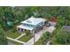 Aerial view of a charming home with a well-manicured lawn, pool, driveway, and garage at 508 Faulkner St, New Smyrna Beach, FL 32168