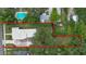 Aerial view of property with well-manicured lawn and in-ground pool at 508 Faulkner St, New Smyrna Beach, FL 32168